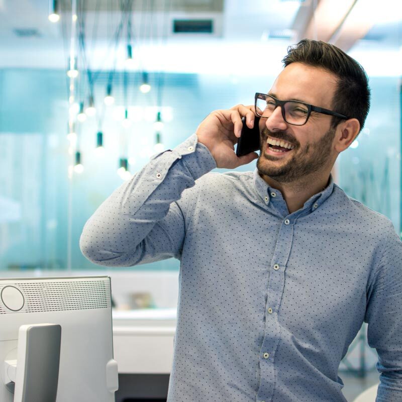 man-smiling-on-phone